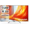 Telewizor z dużym ekranem wyświetla obraz z pomarańczową tkaniną, a na ekranie widoczne są napisy: "QLED", "wysoka jasność", "SOUND BY harman/kardon", "SLIM TV" oraz logo "SHARP".