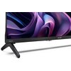 Telewizor z widocznym logo "SHARP" na dolnej ramce oraz napisem "AQUOS" na podstawie, wyświetlający abstrakcyjny, kolorowy wzór. Urządzenie stoi na dwóch nóżkach, a ekran ma cienką ramkę.