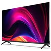 Telewizor z cienką ramką i dwoma nóżkami, wyświetlający kolorową grafikę z dominującymi odcieniami różu, fioletu i pomarańczu. Na dolnej ramce widoczne jest logo "SHARP".