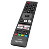 Pilot z czarną obudową i przyciskami, w tym dedykowane przyciski do aplikacji takich jak Netflix, Prime Video, YouTube i Disney+. Na dole pilota widoczne jest logo "AQUOS SHARP".