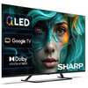 Na zdjęciu znajduje się telewizor z wyświetlonymi napisami: "QLED", "Google TV", "Dolby Vision-Atmos" oraz logo "SHARP". Ekran przedstawia twarz osoby z zielonymi i pomarańczowymi akcentami na skórze oraz włosach.