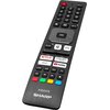 Pilot do telewizora z widocznymi przyciskami, w tym dedykowanymi do aplikacji takich jak Netflix, Prime Video, YouTube i Disney+. Na dole pilota znajduje się logo "AQUOS SHARP".