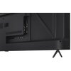Tył telewizora z widocznymi portami i złączami, w tym HDMI i USB, oraz nóżką wspierającą. Obudowa ma ciemny kolor, a na powierzchni znajdują się otwory wentylacyjne.