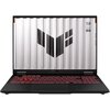 Laptop z otwartym ekranem, na którym widoczny jest duży, czarny symbol na tle przypominającym metalowe panele. Klawiatura podświetlona na czerwono, a na ekranie widnieje tekst: "TUF STAY TUNED STAY TOUGH".