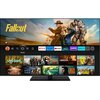 Telewizor wyświetla ekran główny z aplikacjami takimi jak Netflix, Prime Video, YouTube, Disney+, Twitch i Amazon Music. Na ekranie widoczne są miniatury seriali, w tym "Fallout", "Upload", "Squid Game", "The Rings of Power" i "Jack Ryan".