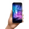 Na zdjęciu widoczna jest dłoń trzymająca smartfon z kolorowym, abstrakcyjnym tłem na ekranie, na który nakładana jest przezroczysta folia ochronna. Produkt to "Folia ochronna 3MK Silky Matt Pro do Apple iPhone 17".