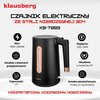 Czajnik elektryczny w kolorze czarnym z elementami w kolorze miedzianym, oznaczony jako model KB-7889, posiada widoczny wskaźnik poziomu wody oraz przycisk otwierania pokrywy. Na zdjęciu znajdują się także opisy: "Dziubek, wylewka wody", "Zasilanie (wł./w