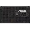 Czarny zasilacz komputerowy z widocznym logo "ASUS" oraz włącznikiem zasilania i gniazdem zasilającym. Obudowa zasilacza ma perforowaną powierzchnię z otworami wentylacyjnymi.