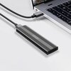Na zdjęciu znajduje się obudowa dysku z napisem "Zenwire" podłączona do laptopa za pomocą kabla USB-C. Laptop ma widoczną klawiaturę z czarnymi klawiszami i białymi oznaczeniami.