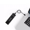Na zdjęciu znajduje się czarna obudowa dysku z widocznym napisem "Zenwire", podłączona kablem do laptopa. Laptop jest częściowo widoczny, z klawiaturą i fragmentem touchpada.