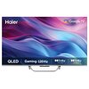 Telewizor z logo "Haier" i "Google TV" na ekranie, z kolorowym tłem w odcieniach fioletu i niebieskiego. Na dole ekranu widnieją napisy: "QLED", "Gaming 120 Hz", "Dolby Vision", "Dolby Atmos".