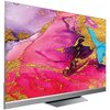 Telewizor z cienką ramką wyświetla abstrakcyjny obraz w intensywnych kolorach różu, fioletu, złota i niebieskiego. Ekran jest umieszczony na prostokątnej podstawie.