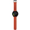 Smartwatch z pomarańczowo-czarnym paskiem i okrągłym wyświetlaczem, na którym widoczny jest tekst: "BATTERY MODE" oraz opcje "Performance 25 hours", "Endurance 55 hours", "Ultra 90 hours". Pasek ma perforowany wzór z otworami w kształcie elipsy.
