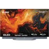 Na zdjęciu widoczny jest telewizor z kolorowym, abstrakcyjnym wzorem na ekranie, z logo "Haier" w lewym górnym rogu oraz napisami "OLED", "SOUND BY harman/kardon", "Dolby Vision IQ", "Dolby Atmos" i "Google TV".