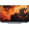 Telewizor z wyświetlaczem OLED prezentuje abstrakcyjny wzór w odcieniach pomarańczowego, czerwonego i czarnego. Na dolnej ramce widoczne jest logo "Haier".