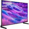 Telewizor z cienką ramką wyświetla obraz w intensywnych odcieniach fioletu i niebieskiego, przypominający falujące pole trawy. W lewym górnym rogu ekranu widoczne jest logo "SAMSUNG", a w prawym dolnym rogu napis "Neo QLED".