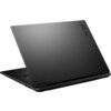 Na zdjęciu widoczny jest czarny laptop z otwartą pokrywą, na której znajduje się napis "TUF". Laptop ma minimalistyczny design z matowym wykończeniem.