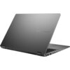 Na zdjęciu widoczny jest laptop w kolorze szarym z logo "ASUS VIVOBOOK" na pokrywie. Laptop jest częściowo otwarty, ukazując klawiaturę i porty po bokach.