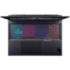 Na zdjęciu widoczny jest laptop z podświetlaną klawiaturą w kolorach tęczy, z wyraźnie zaznaczonymi klawiszami funkcyjnymi i dużym touchpadem. Na obudowie znajduje się logo producenta w dolnym rogu.