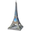 Model 3D Wieży Eiffla z puzzli, złożony z elementów o niebiesko-szarej kolorystyce, umieszczony na podstawce z napisem "TOUR EIFFEL". Konstrukcja składa się z wielu drobnych elementów, które tworzą charakterystyczny kształt wieży.