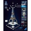 Na zdjęciu znajduje się model 3D Wieży Eiffla z puzzli, złożony z 243 elementów, z oznaczeniem "EASYCLICK TECHNOLOGY" oraz informacją o wysokiej jakości plastikowych elementach w kilku językach. Widoczne są także kolorowe diody LED, sugerujące możliwość p