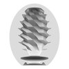 Owalny przedmiot z widocznym przekrojem, ukazującym wewnętrzną strukturę z falistymi, spiralnymi wypustkami. Materiał jest jednolicie szary, a powierzchnia ma gładkie wykończenie.