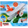 Opakowanie przedstawia model dwupłatowca z postacią Sonic siedzącą w kokpicie, z napisem "SONIC THE HEDGEHOG" oraz informacją o sześciu dźwiękach z gry. Widoczne są również napisy: "SONIC FIGURE INCLUDED" oraz "1 SET / JEU / JUEGO".