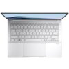 Srebrny laptop z widoczną klawiaturą i dużym touchpadem, na ekranie widoczny jest napis "ASUS Zenbook". W prawym dolnym rogu klawiatury znajduje się logo "Dolby Vision".