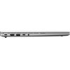 Srebrny laptop widoczny z boku, z zamkniętą pokrywą, posiada różne porty, w tym USB-C, HDMI, USB-A, gniazdo audio oraz inne złącza. Obudowa jest smukła i minimalistyczna.