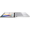 Na zdjęciu widoczny jest laptop otwarty na płasko, z ekranem wyświetlającym grafikę z napisem "ASUS Vivobook". Klawiatura jest jasna, a obok niej znajduje się duży touchpad.