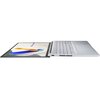 Srebrny laptop z ekranem OLED jest otwarty na płasko, ukazując klawiaturę i touchpad. Na ekranie widoczna jest grafika z napisem "ASUS Vivobook".