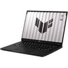 Na zdjęciu znajduje się otwarty laptop z widocznym logo producenta na dolnej ramce ekranu. Na ekranie wyświetlany jest wzór graficzny oraz tekst: "TUF", "STAY TOUGH".