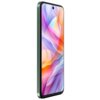 Smartfon z dużym wyświetlaczem, na którym widoczna jest kolorowa, abstrakcyjna grafika z dominującymi odcieniami fioletu, pomarańczu i różu. Obudowa urządzenia ma zielony kolor, a na ekranie znajduje się mały otwór na aparat.
