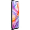Smartfon z dużym ekranem o przekątnej 6.7 cala, wyświetlający kolorową, abstrakcyjną grafikę. Obudowa urządzenia jest w kolorze szarym, a na górze ekranu widoczna jest przednia kamera.