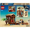 Opakowanie zestawu LEGO 75636 przedstawia model chatki w wiosce z elementami takimi jak palma, łódka i postacie. Widoczne są także szczegóły konstrukcji oraz logo LEGO, a w rogu znajduje się informacja o dołączonym losowym plakacie "Wanted".