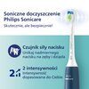 Na zdjęciu znajduje się niebieska szczoteczka soniczna z napisem "PHILIPS Sonicare" oraz tekstem: "Soniczne doczyszczenie Philips Sonicare. Skutecznie, ale bezpiecznie! Czujnik siły nacisku Unikaj nadmiernego nacisku na zęby i dziąsła. 2 intensywności Int