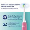 Szczoteczka soniczna w kolorze różowym z widocznym napisem "PHILIPS Sonicare" oraz tekstem: "Soniczne doczyszczenie Philips Sonicare. Skutecznie, ale bezpiecznie! Czujnik siły nacisku Unikaj nadmiernego nacisku na zęby i dziąsła. 2 intensywności Intensywn