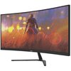 Zakrzewiony monitor z logo "acer" na dolnej ramce wyświetla kolorową grafikę przedstawiającą postać stojącą w polu traw, z rozmytymi światłami w tle. Monitor ma smukłą podstawę i nowoczesny design.