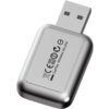 Na zdjęciu znajduje się czarny adapter USB z napisem "CarPlay Wireless Adapter" oraz symbolami certyfikacyjnymi. Adapter ma zaokrąglone krawędzie i metaliczną obudowę.