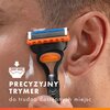 Na zdjęciu widoczna jest golarka przyłożona do twarzy, z napisem "PRECYZYJNY TRYMER do trudno dostępnych miejsc" oraz ikoną trymera. W tle widać fragment skóry pokrytej pianką do golenia.