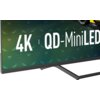 Na zdjęciu widoczny jest fragment telewizora z napisem "4K QD-MiniLED" na ekranie. W tle widać kolorowy wzór, a dolna część obudowy telewizora jest czarna.