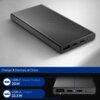 Czarny powerbank z trzema portami widocznymi na jednym z boków, leży na jasnej powierzchni. Na dole zdjęcia znajduje się napis: "Charge 3 Devices at Once." oraz informacje o portach: "USB-C Input/Output 20W" i "USB-A Output 22.5W".