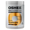 Pojemnik z napisem "OSHEE ISO Hydration Powder Hydro Synergy Complex" zawiera informacje o składnikach, takich jak 5 elektrolitów (sód, potas, chlorki, magnez, cynk) oraz 9 witamin. Na etykiecie widnieje również napis "Orange Flavour L-Carnitine" oraz ozn