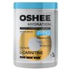 Pojemnik z napisem "OSHEE HYDRATION" zawiera informacje o produkcie izotonicznym w proszku o smaku pomarańczowym, z dodatkiem L-karnityny, pięcioma elektrolitami i dziewięcioma witaminami, oraz oznaczeniem "ZERO SUGAR". Na etykiecie widnieje także napis "