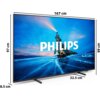 Telewizor marki PHILIPS z wyświetlaczem pokazującym krajobraz z górą i niebem, na którym widnieje duży napis "PHILIPS". Wymiary telewizora to 167 cm szerokości, 99 cm wysokości, 97 cm wysokości ekranu oraz 32,5 cm głębokości podstawy.