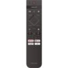 Pilot z napisem "AMBILIGHT" na górze, posiada przyciski do sterowania telewizorem, w tym dedykowane przyciski do aplikacji takich jak Netflix, YouTube i Prime Video. Na dole znajduje się logo "PHILIPS".
