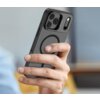 Na zdjęciu widoczne jest czarne, matowe etui na telefon z trzema wycięciami na aparaty oraz okrągłym wzorem na tylnej części. Etui jest trzymane w dłoni, a w tle znajduje się rozmyte wnętrze pomieszczenia.