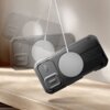 Czarne etui TECH-PROTECT Kevlar MagSafe do Apple iPhone 17 jest zawieszone na białym kablu, z widocznym okrągłym elementem MagSafe. Na etui znajduje się napis "TECH PROTECT".