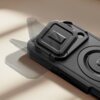 Czarne etui TECH-PROTECT Kevlar MagSafe do Apple iPhone 17 Pro Max z widocznym uchwytem i okrągłym wycięciem na aparat, leży na jasnym tle. Etui ma teksturowaną powierzchnię i wyraźne detale konstrukcyjne.