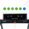 Na zdjęciu widoczny jest panel sterowania bieżni elektrycznej z wyświetlaczem pokazującym dane: "DISTANCE 1.2", "TIME 15:01", "SPEED 10.5", "CALORIES/PULSE 83". Poniżej znajdują się przyciski z oznaczeniami: "PROG", "START", "STOP", "MODE" oraz logo "TUNT